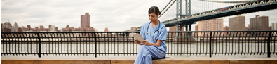 Image of medical professional sitting by the water.