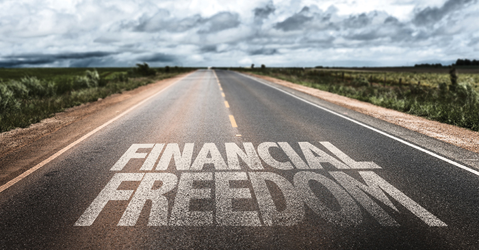A roadway with text, text reads financial freedom
