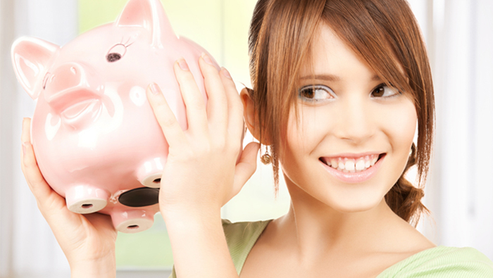 a young woman holding a piggy bank