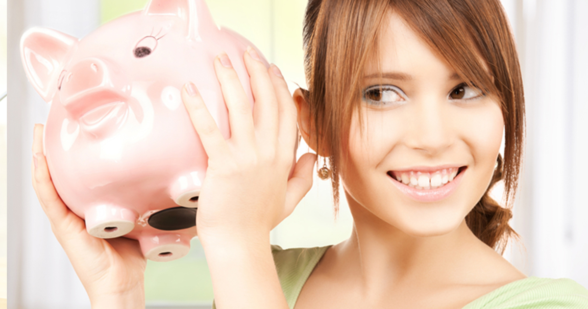young woman holding a piggy bank